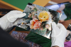 Lab Staff holding an image of a cactus flower printed on kodak professional metallic paper