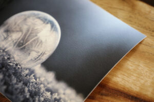 Corner of a fine art giclee print of a frozen bubble printed on canson edition etching slighty textured fine art