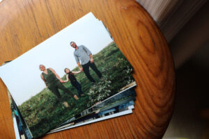 Pile of lustre photo prints of a family on a wooden stool