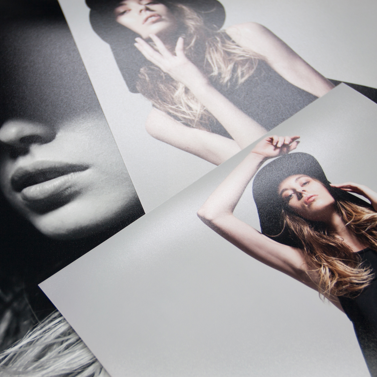Pile of photographic lustre prints of a model wearing black