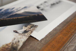 Pile of fine art prints on canson rag paper with straight and torn edges