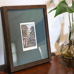 Framed original balinese artwork with dark green matting and a dark wood frame