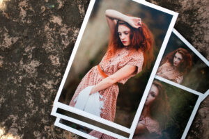 Pile of lustre photo prints all of a red haired female model