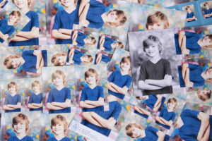 Pile of different styles of school package prints scattered over a table school photo printing