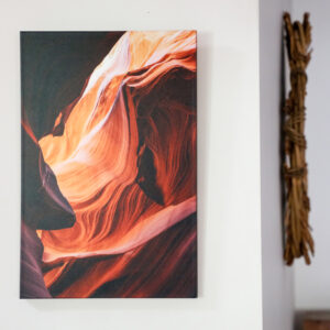 Photo pearl wrap with image of the inside of a cave on a wall with other artworks in the background